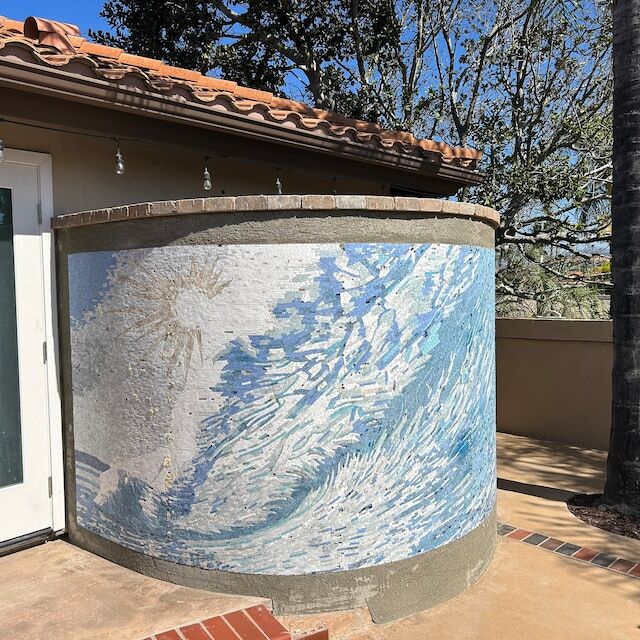 Abstract seascape mosaic on a curved outdoor wall