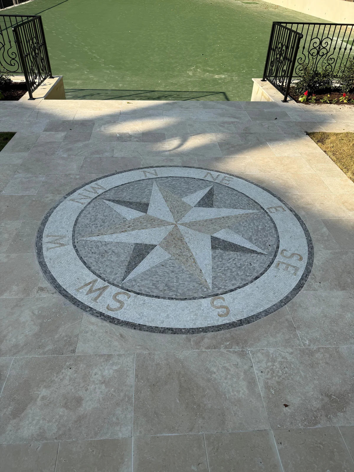 Double compass geometric mosaic medallion on a patio