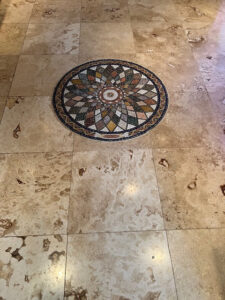 Geometric marble mosaic medallion in a stone floor