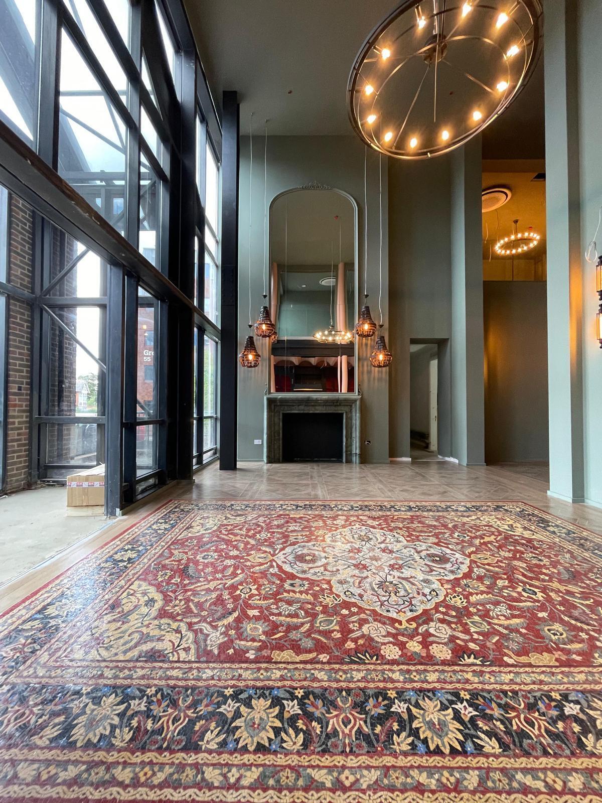 Persian rug design marble mosaic floor in a hallway
